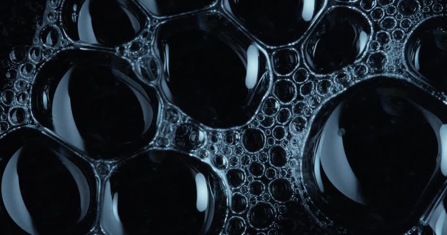 Light shines on bubbles as they move in liquid
