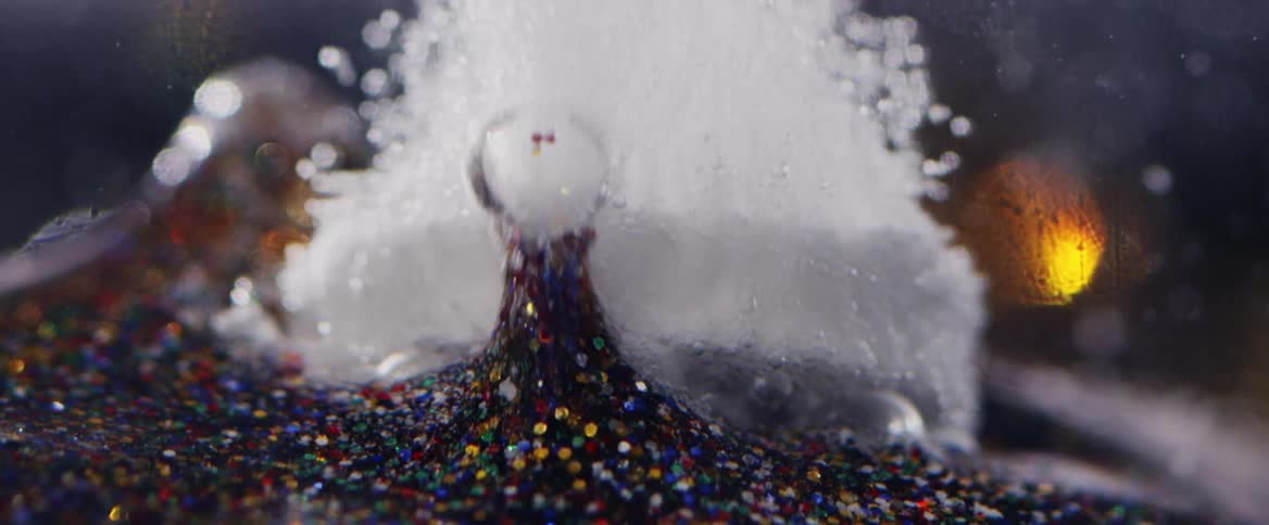 Dense abstract liquids with shimmer and bubbles moving in opposite looping motion