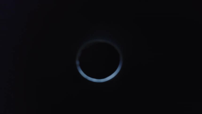 Blue light passes over hole before the area fades to black