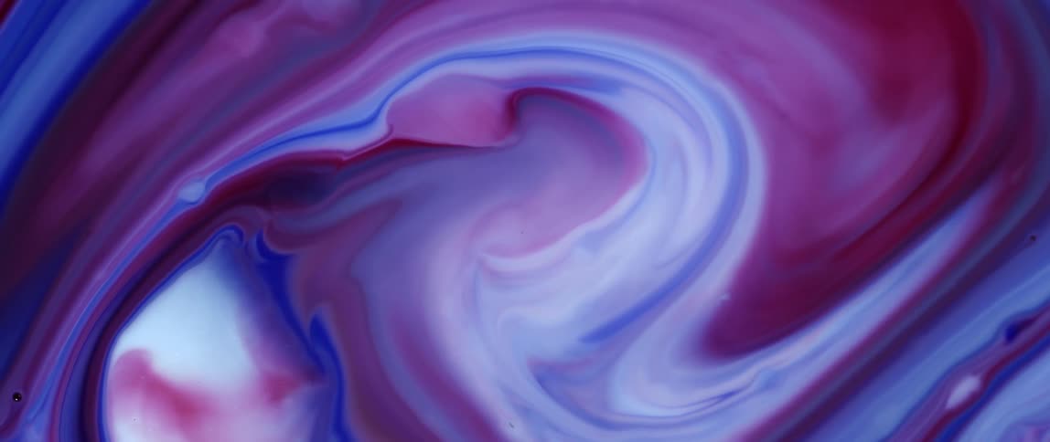 A liquid of red and blue colors moving in a spiral shape