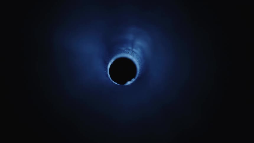 Flashlight shines light down a pipe