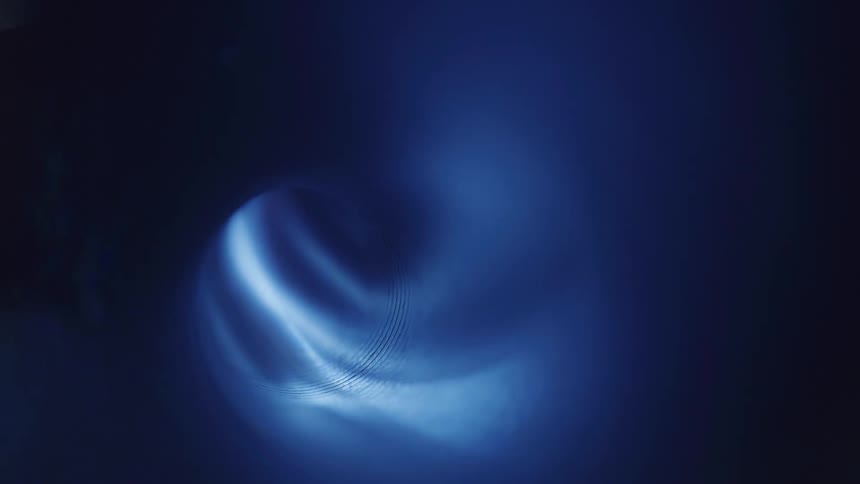 A light shines into the dark tube