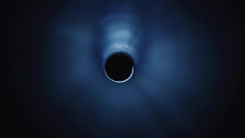 A metallic hole glowing with light
