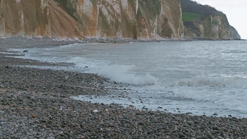 Sea waves roll onto a rocky beach