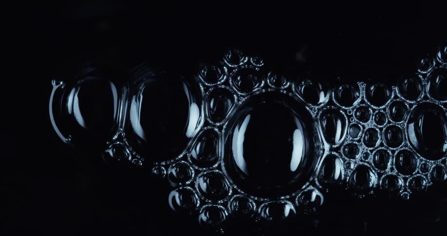 Liquid bubbles forming round shapes in the dark