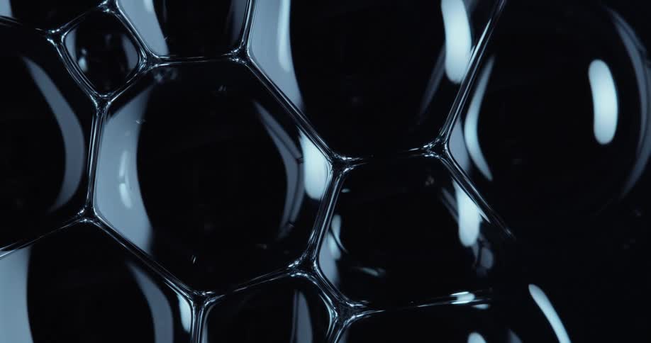 Several united and shiny bubbles in a black environment