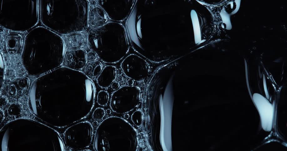 Dense liquid and abstract bubbles connected to each other on a black background