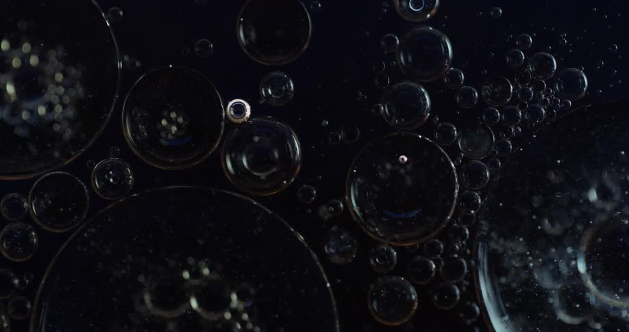 A dark environment with many bubbles and some are being lit quickly