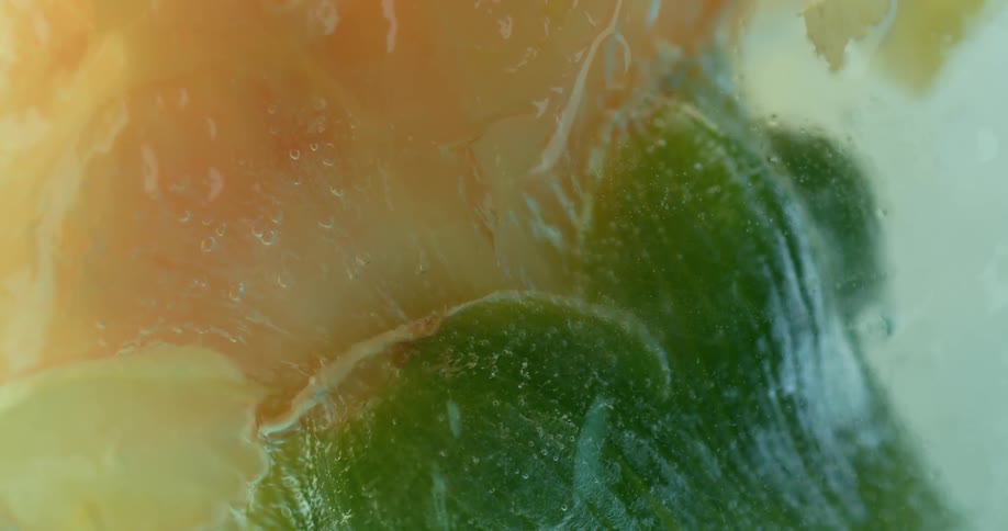 Extreme closeup on an abstract gelatinous green and orange object