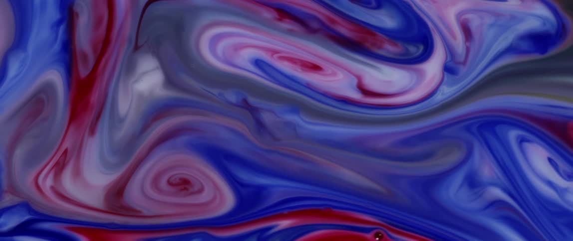 Liquid colored stripes swirl and blend as more colors splash upon the mixture as it moves
