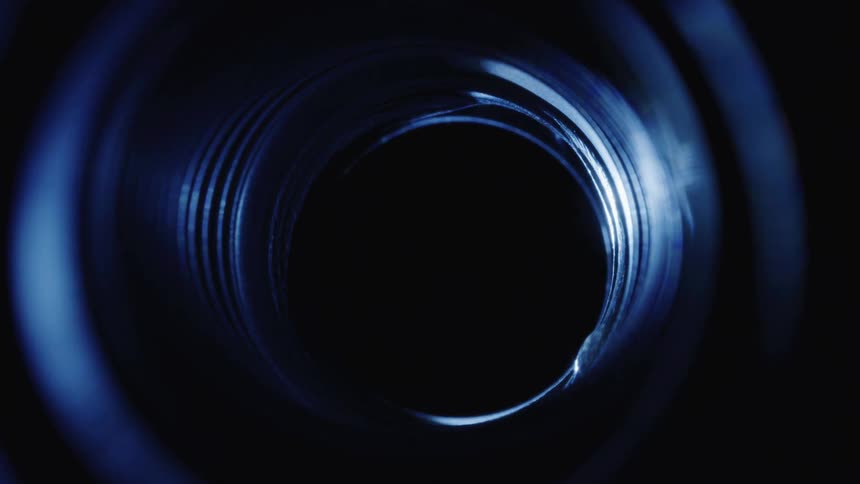 A small beam of light passing through an abstract cylinder