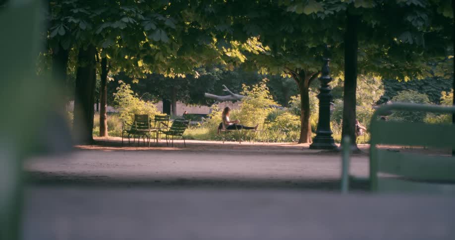 Person sitting on a bench in a public square