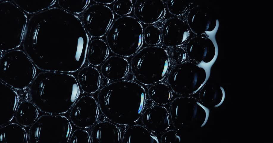Several bold reflected bubbles together on a black background