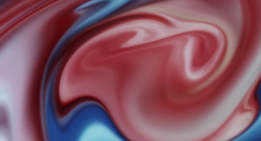 Dense abstract liquid blending in blue and pink colors orbiting in motion