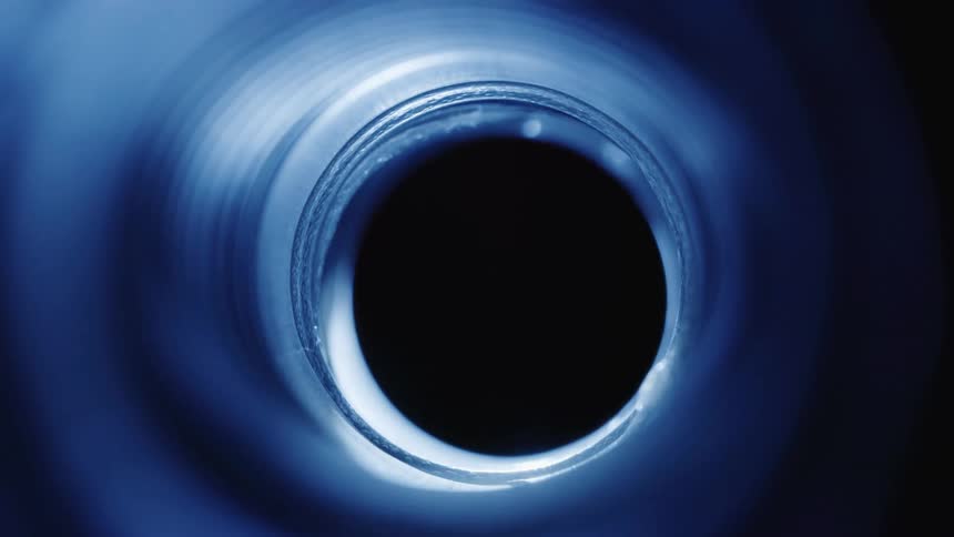 A bluewalled hole being lit by a glowing light fountain passing by