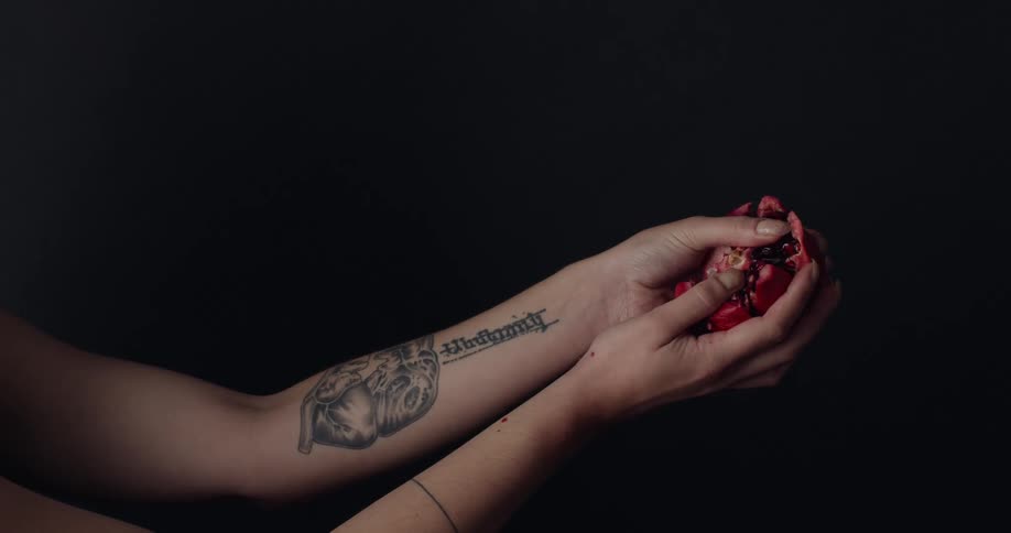 A person is tearing a piece of fruit open
