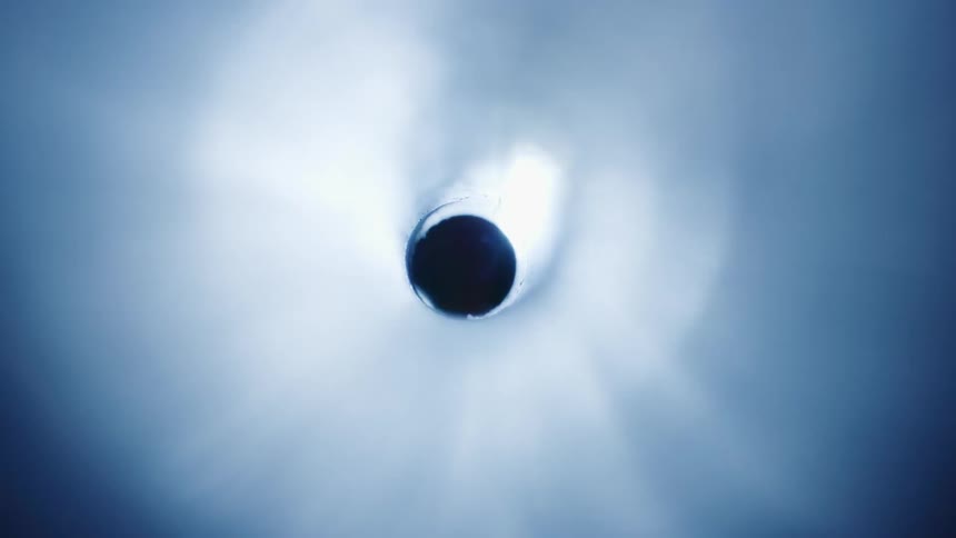 A light shines into the dark tube
