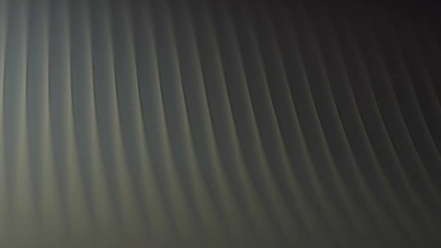 Light passing through an abstract object in the midst of darkness