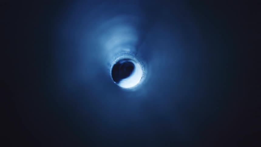 Light brightens illuminating a hole then fades out leaving darkness