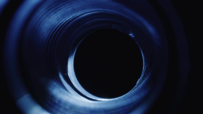 Light passing beneath an abstract and dark cylinder