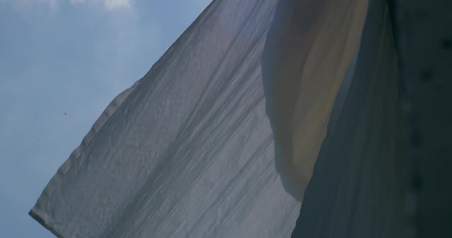 A white fabric flapping against the wind