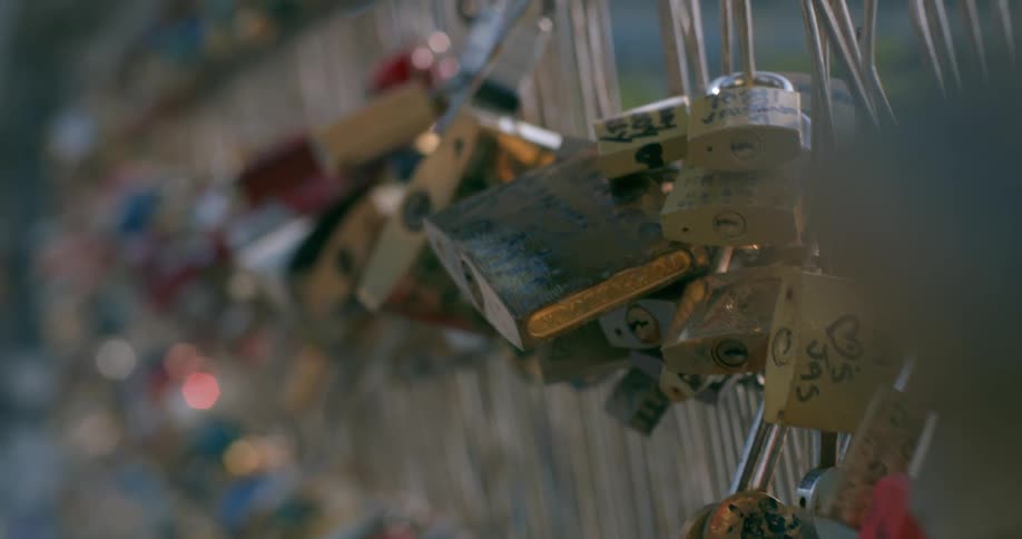 Padlocks fastened to a wire fence