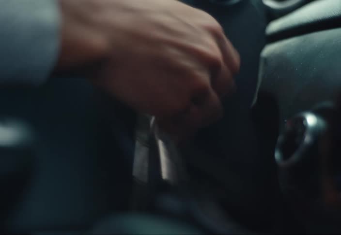 A person turning on and off the ignition key of a car