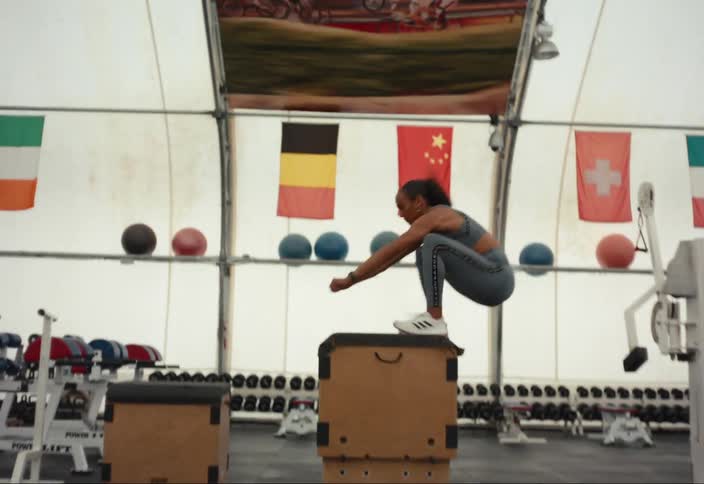 Athlete does box jumps in the gym