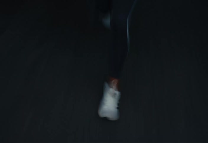 Sped up footage of a woman running on a road