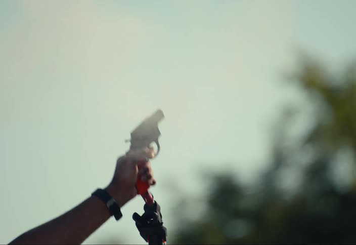 Someone shoots a gun up in the air to start a race