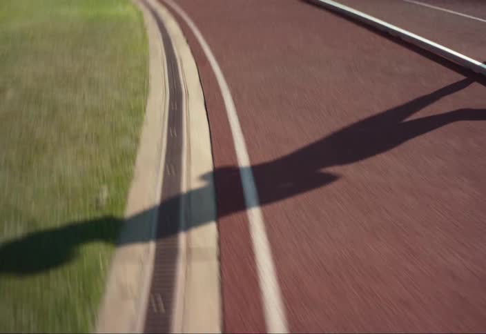 A woman jogs around a track