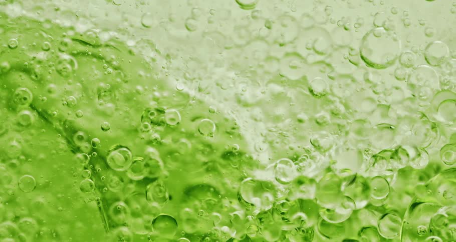 Close up of air bubbles suspended on a green liquid