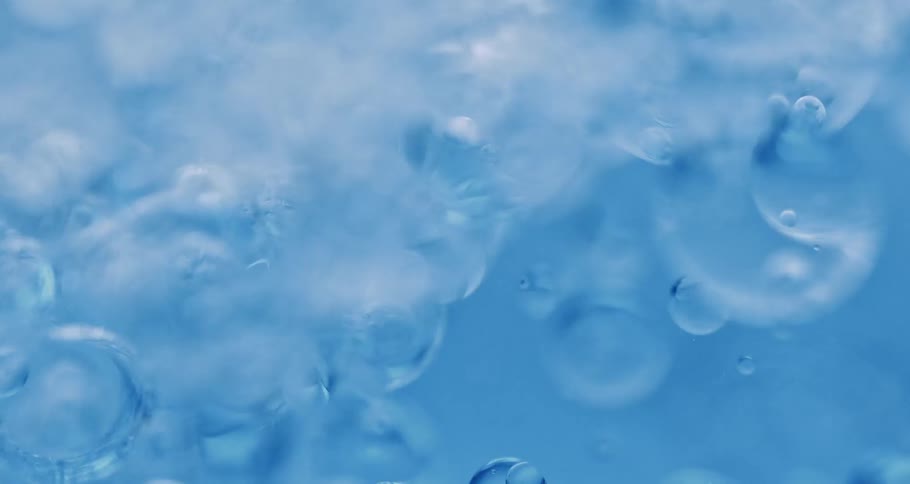 Clear liquid with bubbles swirling around
