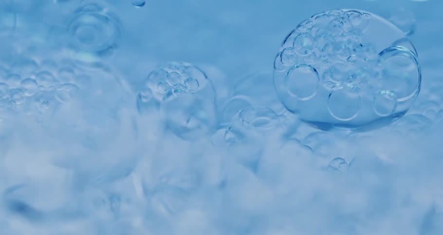 Blue liquid with bubbles flowing smoothly