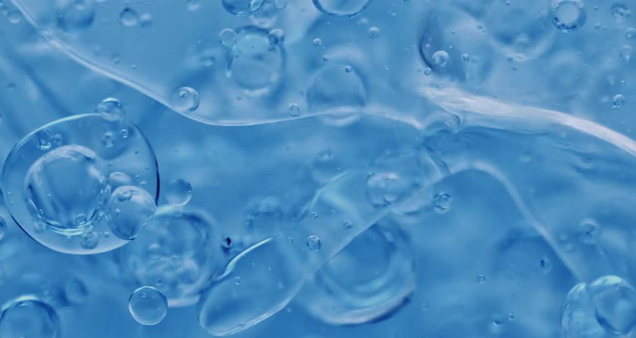Air bubbles rising on a blue liquid