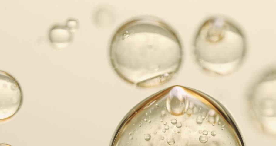 Gold outlined transparent bubbles flow downward