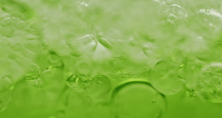 Green liquid with various abstract bubbles in motion