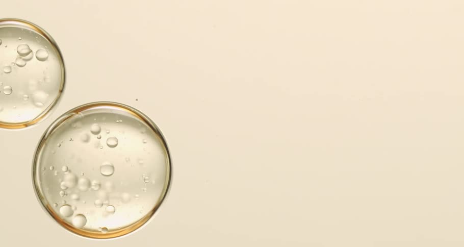Light shines upon clear orbs with bubbles inside as they float downward
