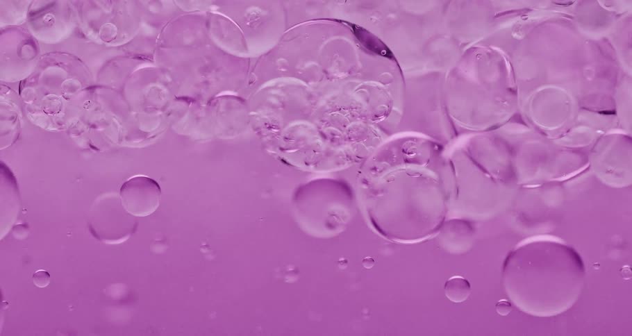 Dense pink liquid with abstract bubbles in motion