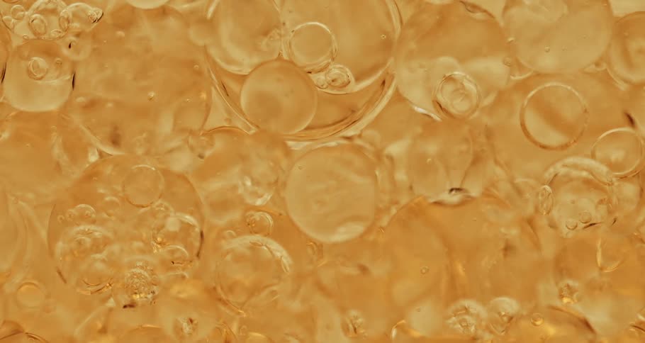 Bubbles flowing in a yellow liquid