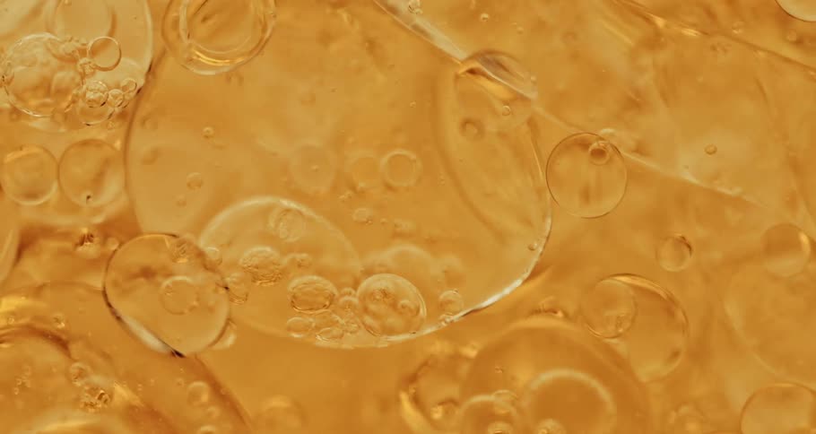 Air bubbles move on a thick yellow liquid