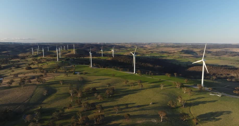 Wind turbines spin on grassland