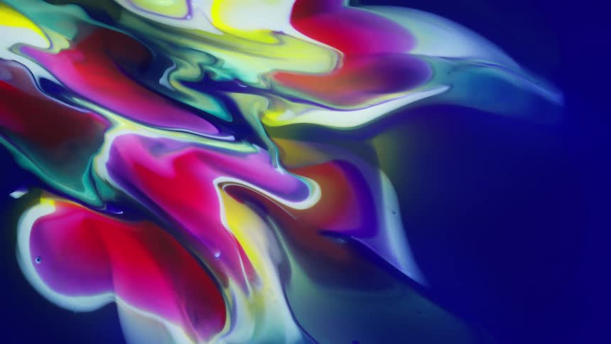 Abstract and colorful dense liquid spreads across a blue canvas