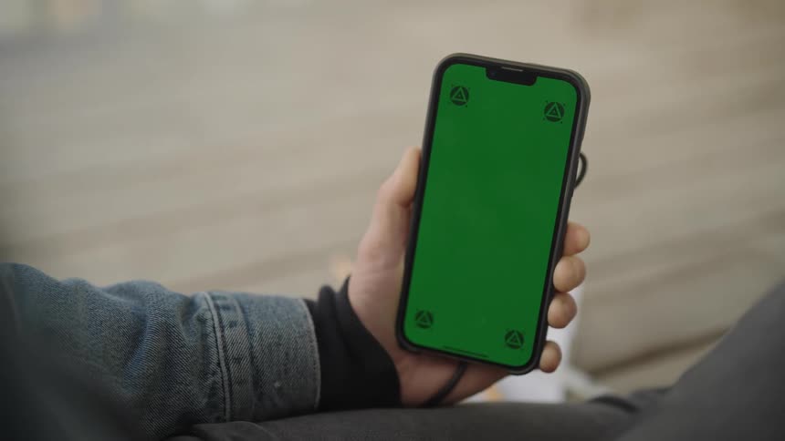 Closeup of a persons hand holding a cellphone