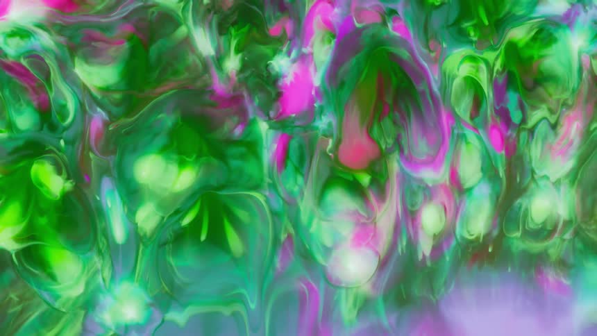 Green and pink paint slowly dripping down a screen as the colors melt together