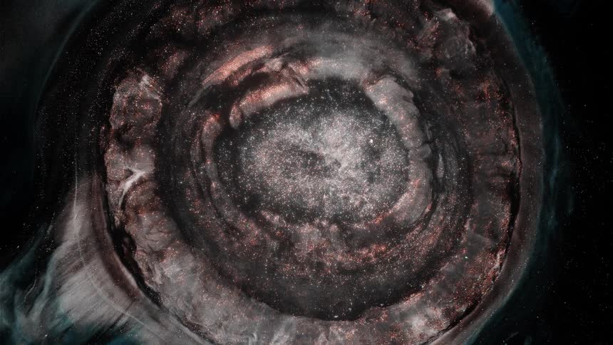 Gaseous layers expand in concentric rings from center against dark background