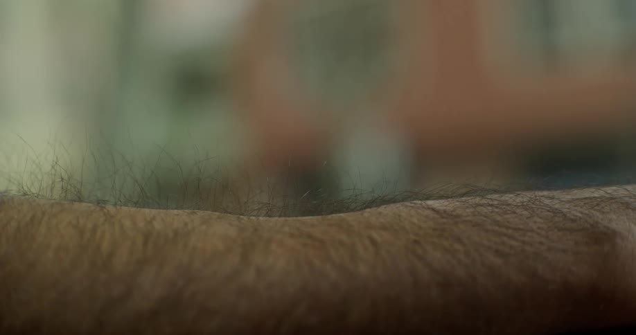 A mans hair on his arm rises up