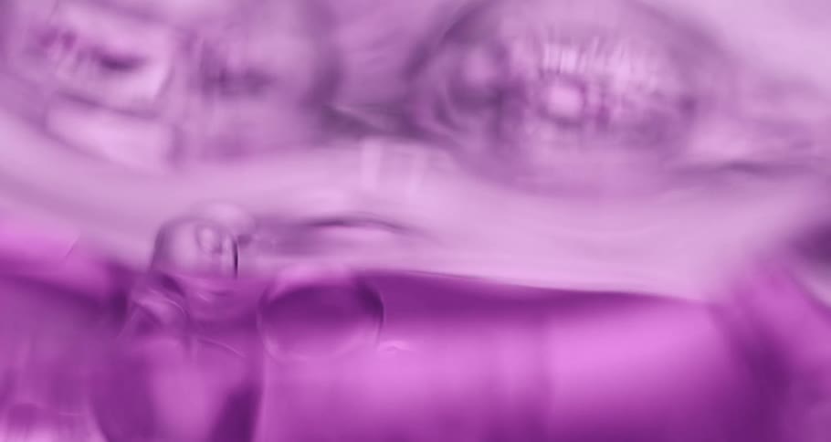 Purple liquid with abstract slowmoving bubbles