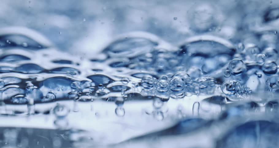 Light shines on bubbles as they float across a liquid substance