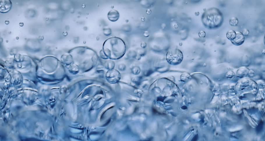 Many bubbles move and float as they swirl in a clear liquid